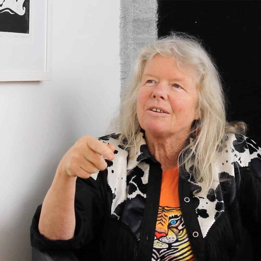 Artist Judy Darragh gesturing while talking