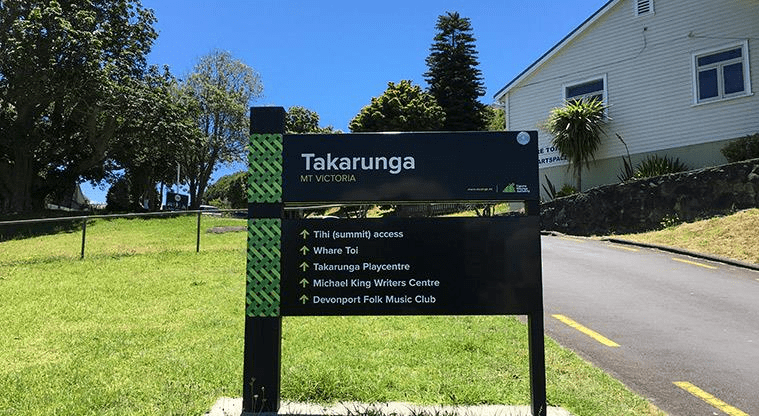 Signage on the slope of Takarunga Maunga (Mount Victoria), overlooking Whare Toi.